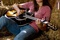 miley cyrus plays guitar