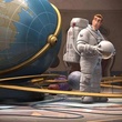 un humain devant un globe terrestre